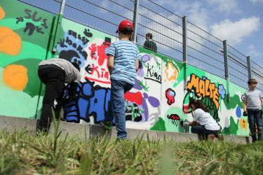 Kinder verschönern den Haltepunkt An den Aspen in Jülich mit Graffiti-Motiven